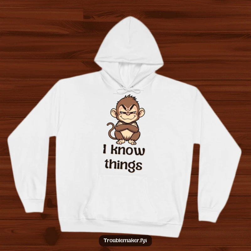 Funny troublemaker monkey, arms crossed with a sly grin, featured on a warm and cozy hoodie.
