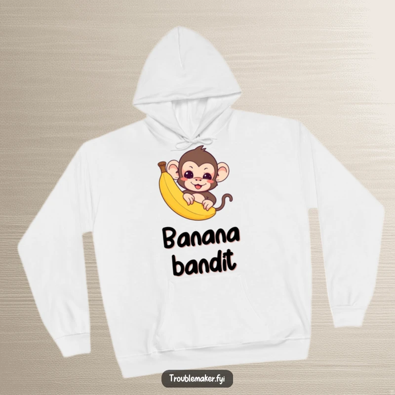 Funny Hoodie: A cute troublemaker monkey peeks mischievously from behind a big banana.