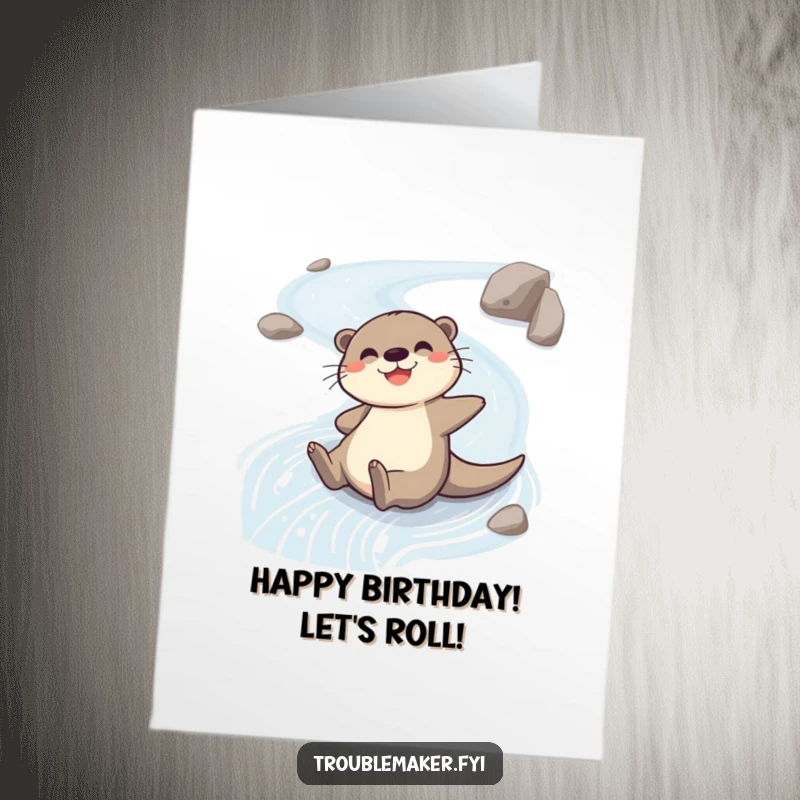 Funny Free Printable Birthday Card: Cheerful otter gleefully sliding down a wet riverbank, wishing a happy birthday with pure excitement.
