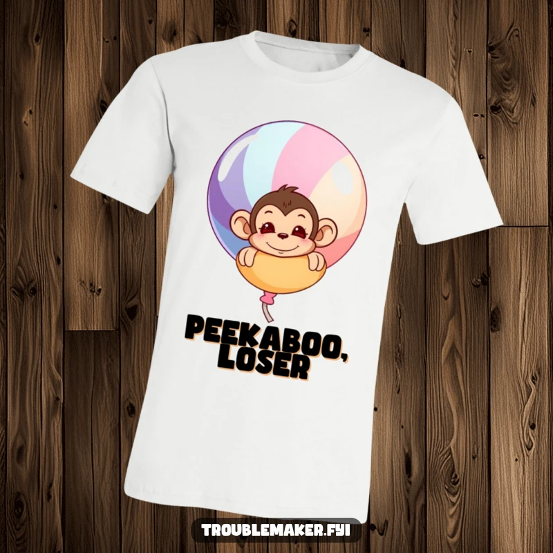 Funny t-shirt with a mischievous monkey peeking from behind a large, vibrant balloon, showcasing a playful and surprising moment.
